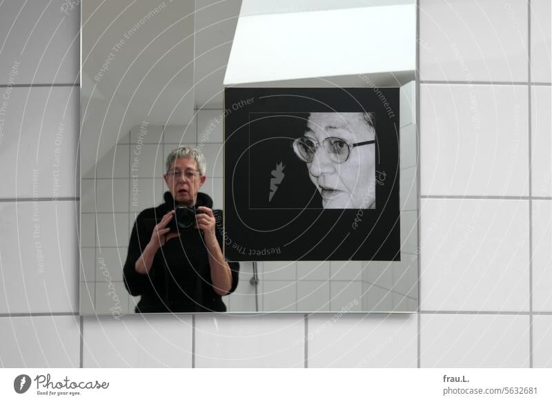 Photo on the mirror Memory Mother eyes see Eyeglasses Old Face portrait Woman photo bathroom Selfie photographer Adults Mirror tiles Bright camera Camera