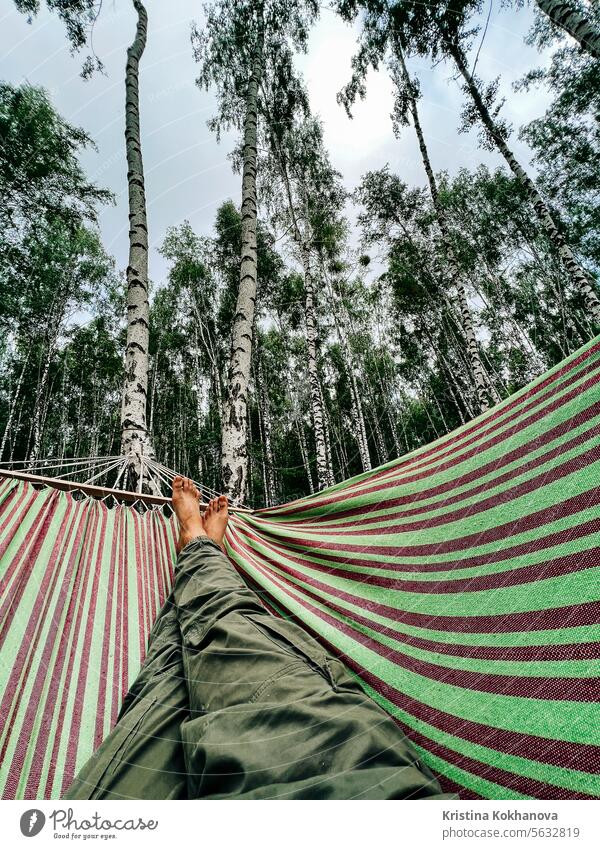 Legs of man, swinging on hammock at summer, birch forest. Enjoying, guy dreaming leisure relax vacation happy holiday nature person woman relaxation comfortable