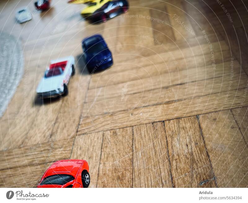 Small toy cars on parquet floor Parquet floor Toy cars Toys matchbox Playing Infancy Children's room Ground