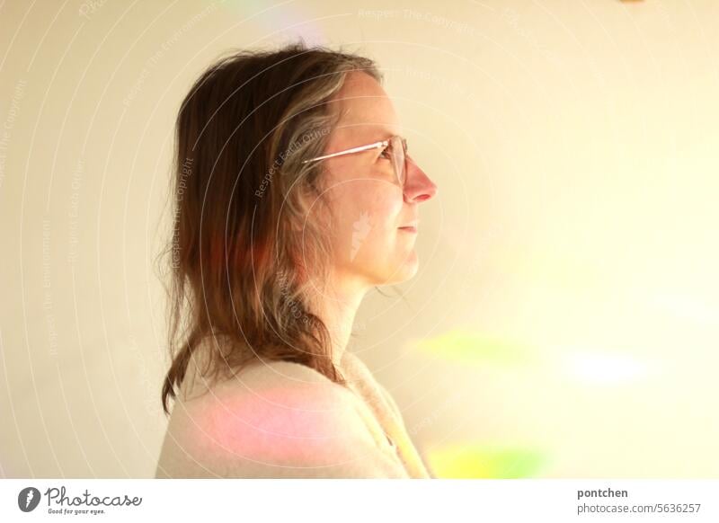 light in rainbow colors on a wall next to a woman. Beam of light Rainbow Hope Joy Happy Light Tolerant Multicoloured Refraction Prismatic colour