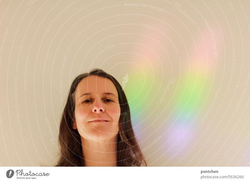 light in rainbow colors on a wall next to a woman. Beam of light Rainbow Hope Joy Happy Light Tolerant Multicoloured Refraction Prismatic colour
