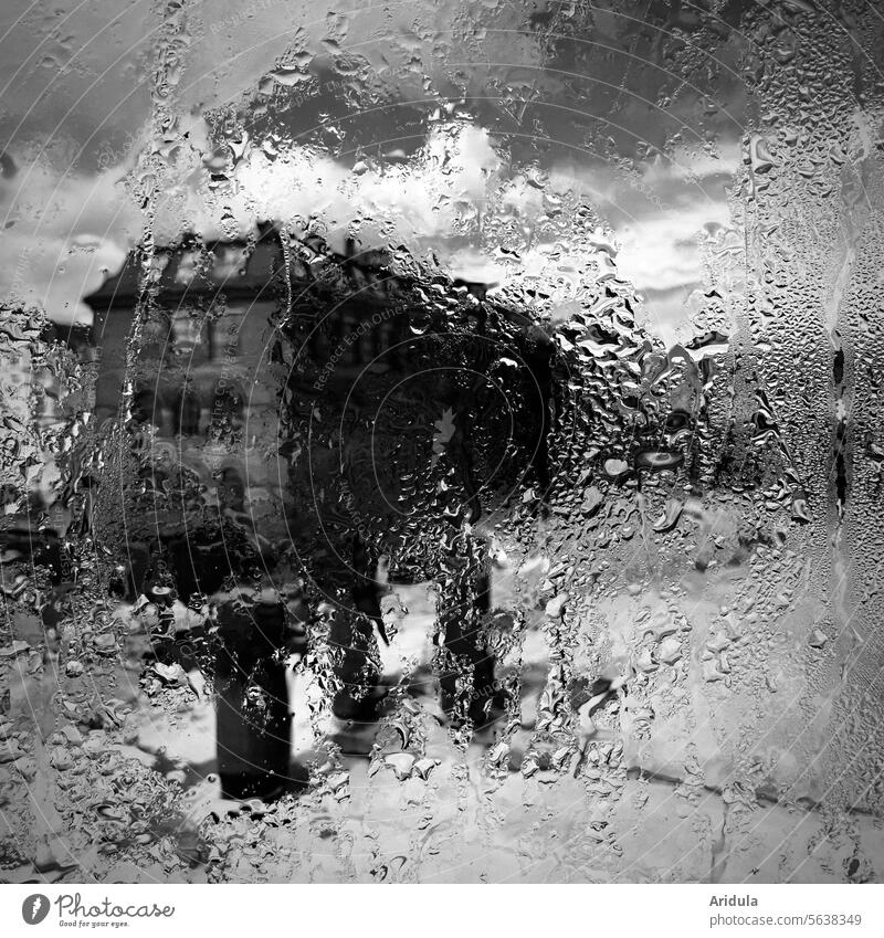 Blurred building behind rainy glass pane b/w Rain raindrops Pane Window Wet Building Vantage point House (Residential Structure) Drops of water Bad weather