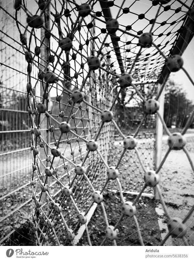 Net of a soccer goal on a sports field b/w Soccer Goal Playing field Sports Foot ball Sporting Complex Sporting grounds Leisure and hobbies Football pitch