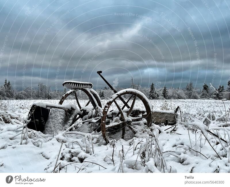 Old farm equipment in the snow and ice Snow antique cold winter cloudy sky trees outdoors rustic Retro