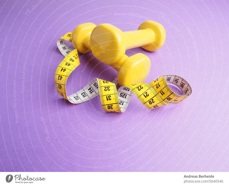 Yellow dumbbells with a measuring tape on a purple background accessories training object sport bodybuilding activity strength yellow exercise fitness health