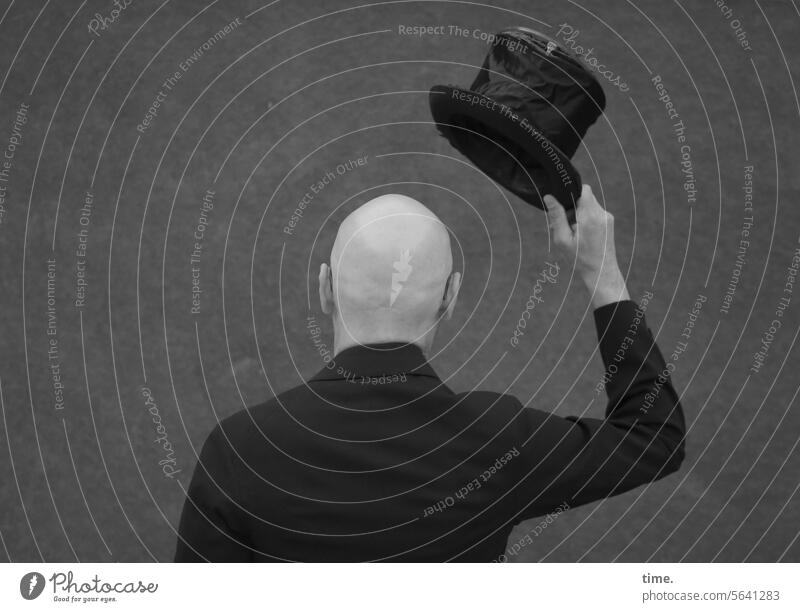 Welcoming rituals | old school Man Suit Cylinder Bald or shaved head salute sb. Rear view Rear side Wall (barrier) Magic wand Black Arm Salutation politeness