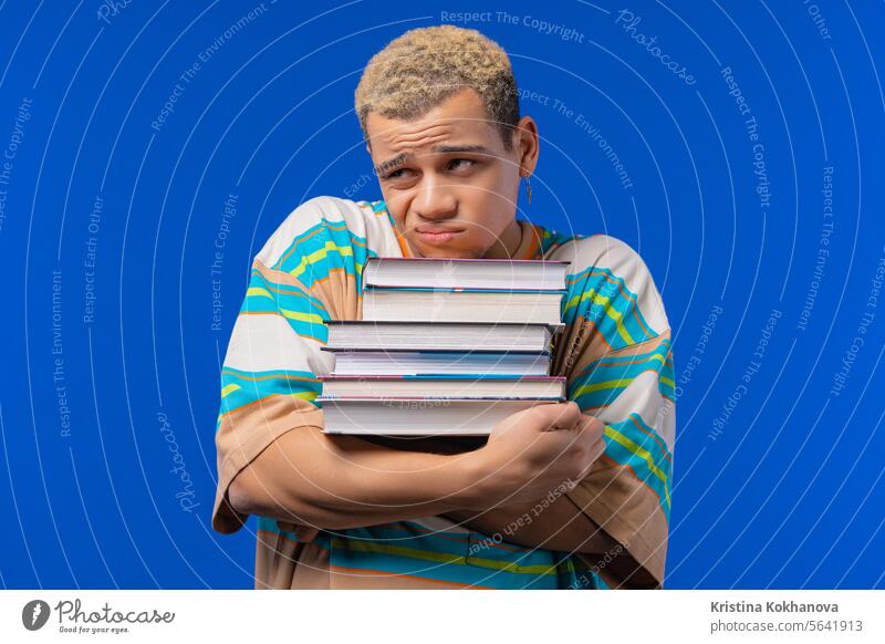Lazy man student is dissatisfied with amount of books, homework in high school adult advertising african american attractive beautiful bored boy casual