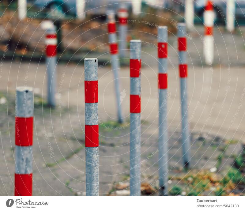 A double row of posts with red stripes on the sidewalk Pole stake Bollard Stripe Red off Street Pattern Row Line Beaded Stand Unwavering walkway Protection lock