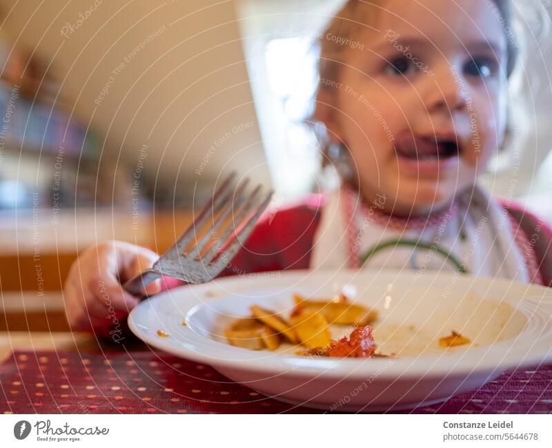 Toddler eating. Eating Food Food photograph Delicious Nutrition Healthy Eating Colour photo Child Red Plate Tongue lap lick taste it tastes good Green Lunch