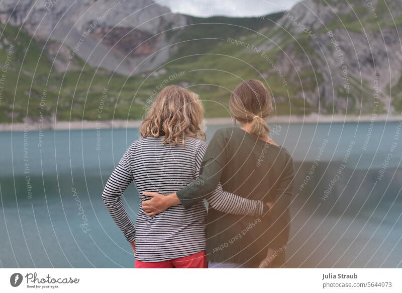 Together in common at the same time Attachment Friends Couple mountain lake Hiking Lünersee mountains women Woman youthful Striped Mountain