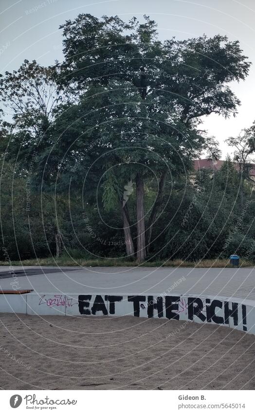Political slogan "Eat the rich" on wall policy Berlin lettering Exclamation announcement typo street photography street life Luxury Anti-capitalism Capitalism