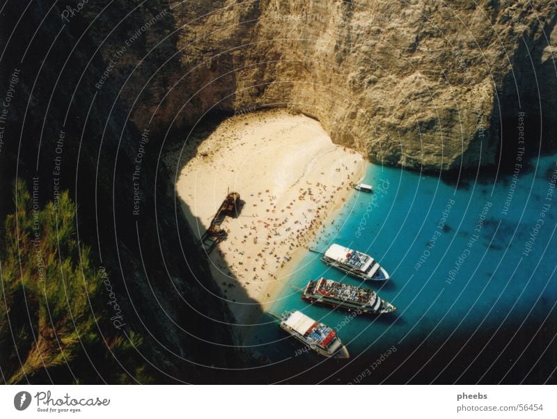 wreck Zakynthos Wall of rock Turquoise Watercraft Green Beige Tree Vacation & Travel blue grotto Bay Rock Human being Swimming & Bathing Blue Sand Branch