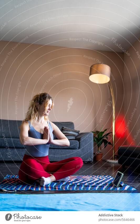 Peaceful Home Yoga Session with Young Woman woman yoga home fitness health wellbeing exercise practice meditation peace calm relaxation indoor lifestyle sitting