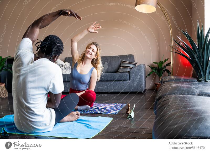 Couple practicing yoga together in a cozy living room couple home wellness exercise fitness health hobby indoor man woman practice mat modern lifestyle