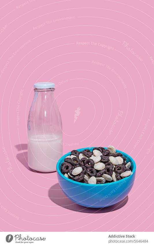 Bowl of Cereal with Chocolate and Bottle of Milk on Pink cereal chocolate milk bottle bowl pink background food breakfast dairy snack blue drink healthy sweet