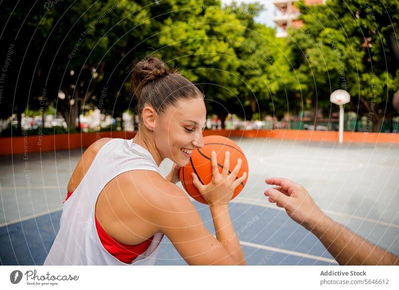 Happy sportswoman playing basketball with friend at court Sportswoman Basketball Play Smile Friend Player Cheerful Playground Together Game Activity Athlete