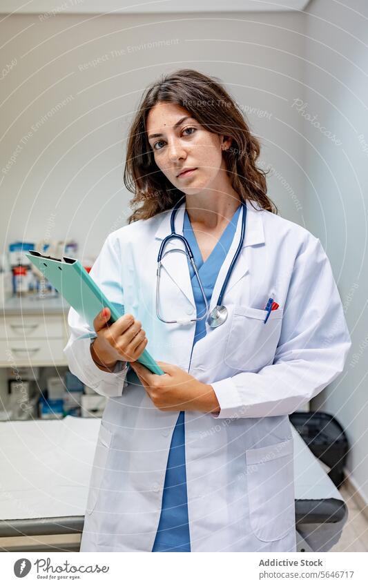 Female doctor in medical uniform with stethoscope and folder at hospital woman nurse clinic professional specialist health care report physician job confident