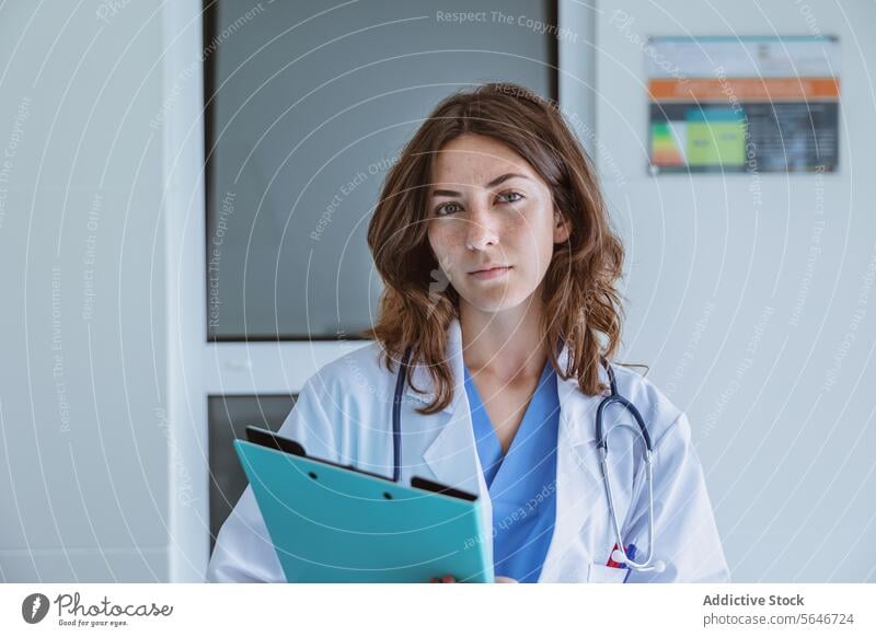 Female doctor in medical uniform with stethoscope and folder at hospital woman portrait nurse clinic professional specialist health care report physician job