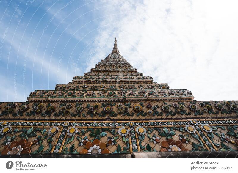Ancient Buddhist temple under blue sky with clouds in Thailand buddhist ornament architecture ancient religion exterior oriental buddhism worship wat pho