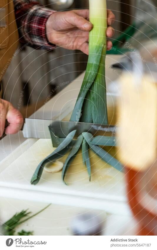 Anonymous person Preparing Leeks in the Kitchen chef hands preparing leeks cutting board kitchen culinary recipe cooking green white neutral tones preparation