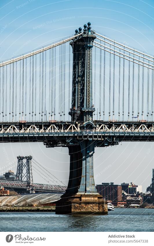 Detailed view of Manhattan's bridge suspension system architecture New York skyline water river landmark structure travel tourism cityscape blue steel
