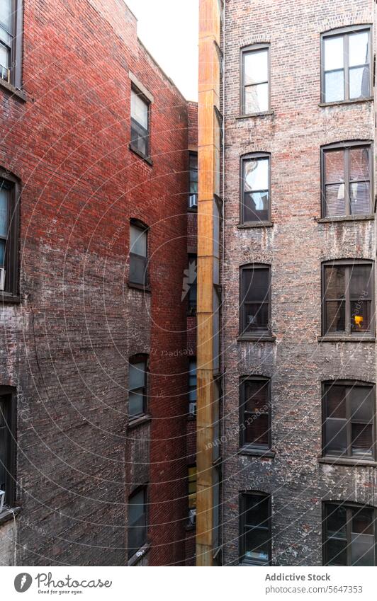 Brick buildings in Manhattan alleyway New York brick window air conditioning old vintage architecture urban city red narrow texture structure exterior