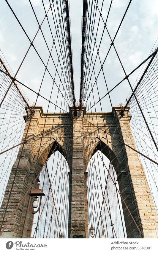 Iconic Brooklyn Bridge cables and pillars bridge architecture Manhattan landmark sky New York structure stone historic travel tourist destination upward view