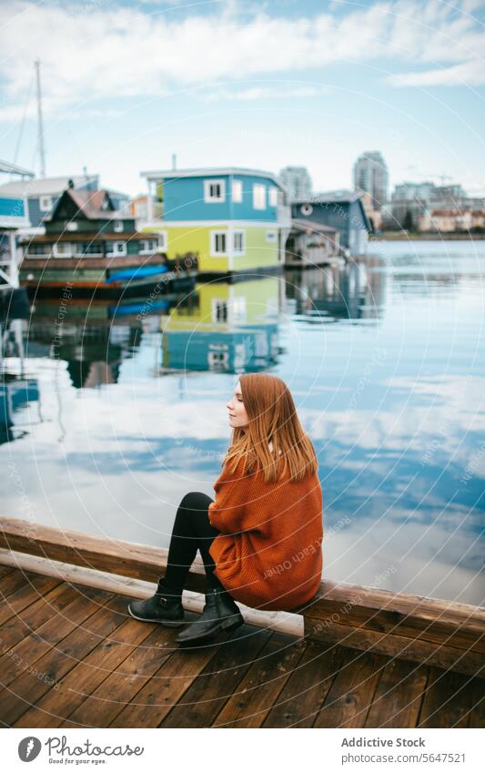 Serene moment at colorful floating houses in Victoria, Vancouver Island woman dock sitting water vancouver island serene contemplative british columbia canada