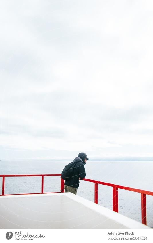 Tranquil moment of unrecognizable man on a ferry deck overlooking the sea person vancouver island british columbia canada water calm contemplative serenity