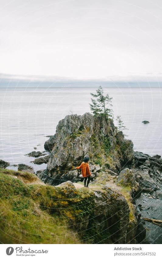 Woman in tranquil moment overlooking the sea of East Sooke Regional Park, Vancouver Island person cliff vancouver island british columbia canada contemplation