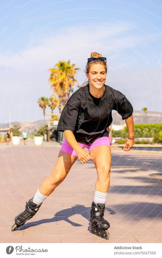 Female skater at beach on sunny day woman rollerskating footpath smiling enjoy sky blue full length blur stylish inline beautiful full body casual physical