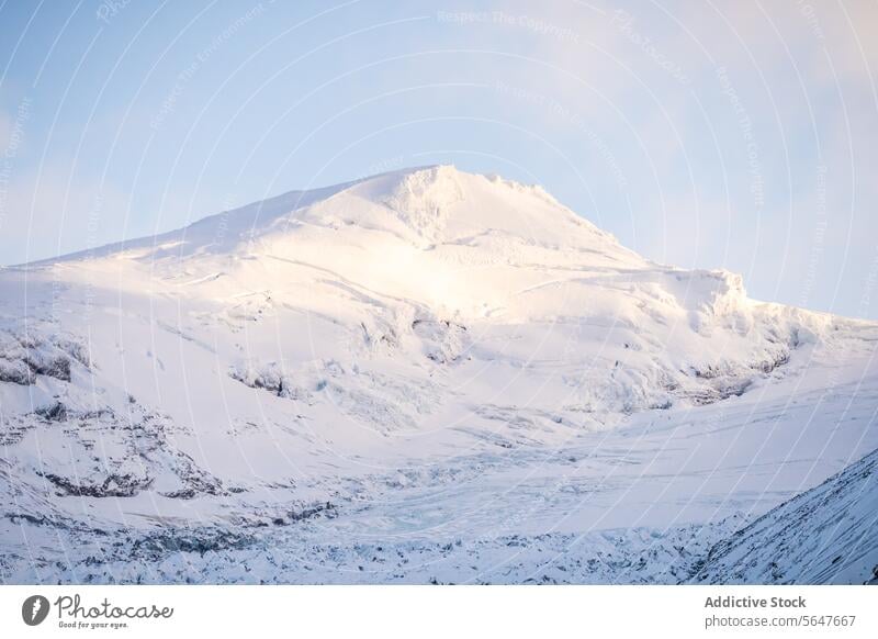 Snow-covered mountain peak under a clear sky in Iceland iceland snow sunlight serene landscape majestic blue outdoor nature scenic cold winter white frost