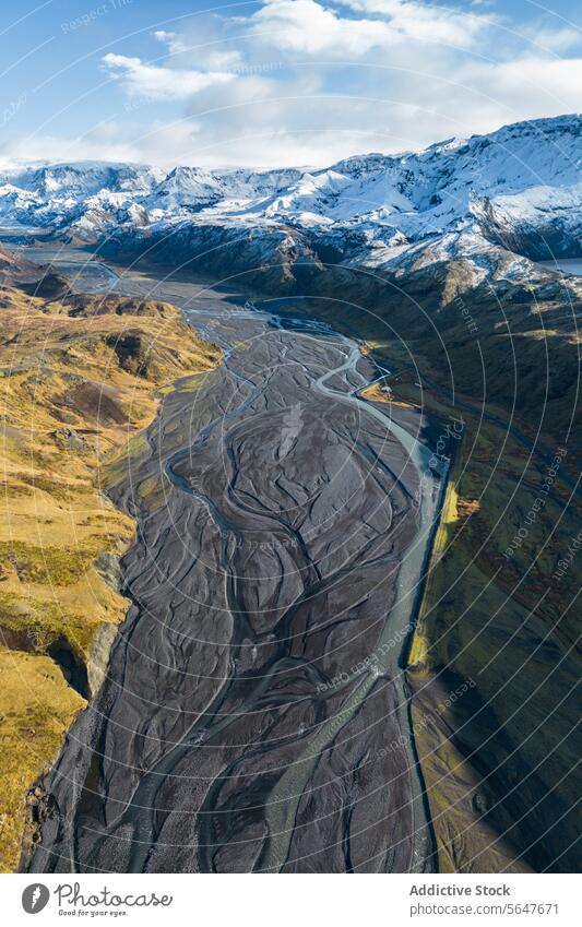 Aerial view of Iceland's majestic landscapes and meandering river iceland aerial view snow mountain dramatic scenery nature outdoor wilderness natural beauty