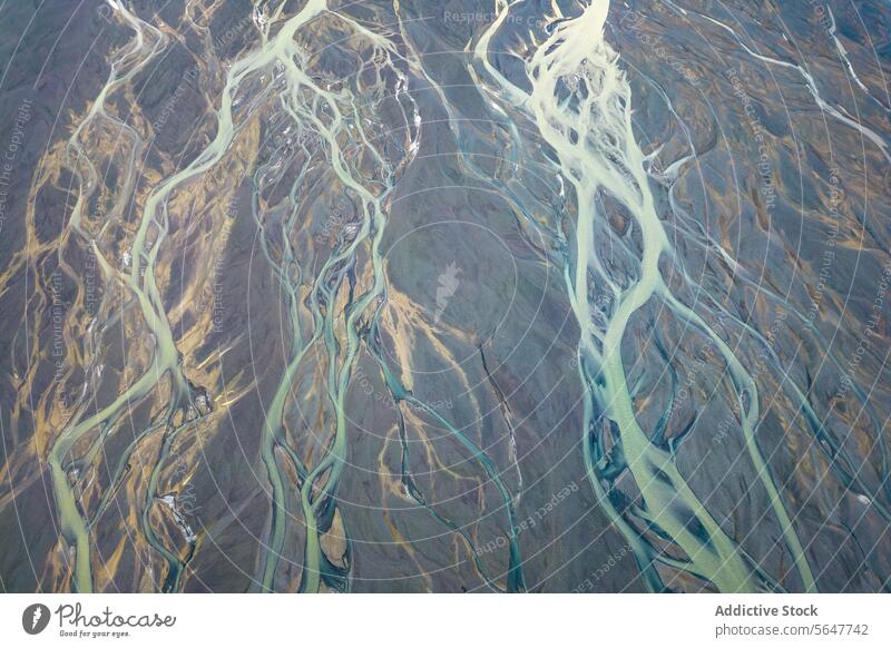 Top view drone image of breathtaking drone view of curvy river estuary amidst mountains in Iceland valley brook ridge creek landscape iceland highland wetland