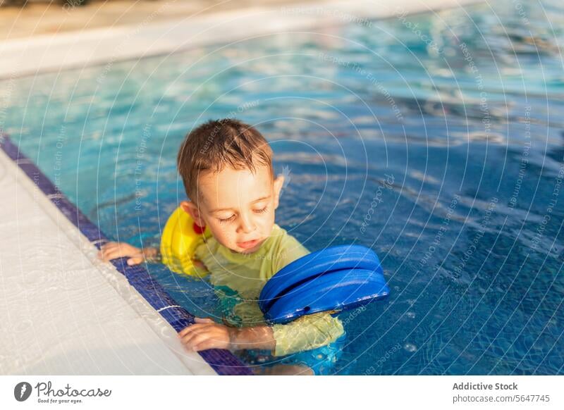 Toddler's Swim Lesson with Floatation Device child swim learn pool floatation device water toddler lesson swimming training safety outdoor summer activity