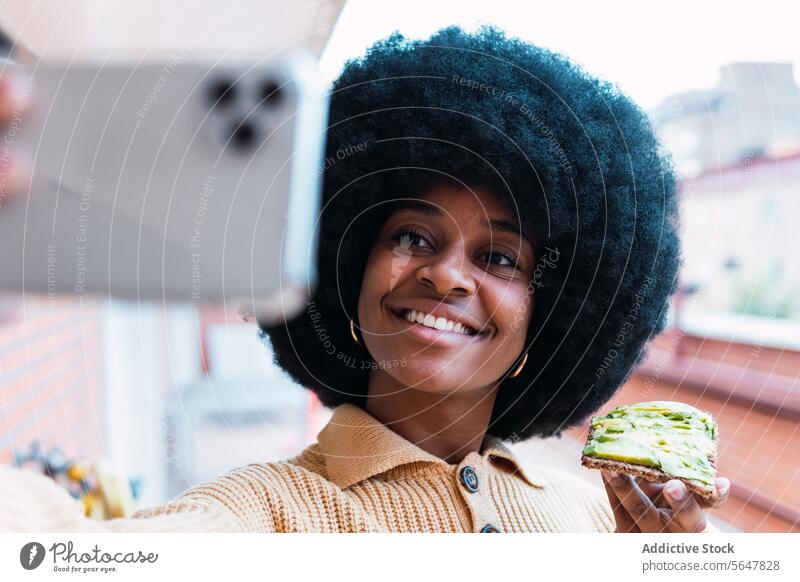 Black woman taking selfie with avocado toast take photo food smartphone using breakfast social media healthy lifestyle morning female african american black
