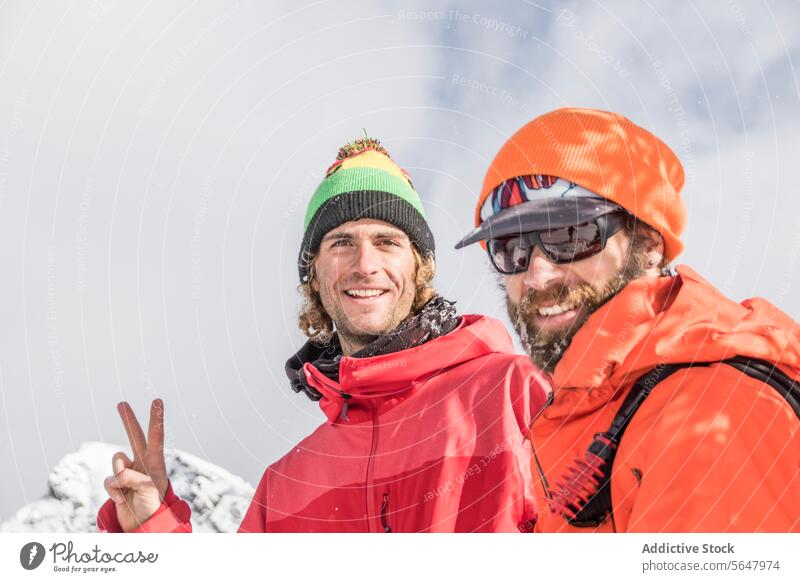 Male friends enjoying vacation together traveler happy smiling warm clothes portrait looking at camera winter hiker canada cheerful gesture sunglasses