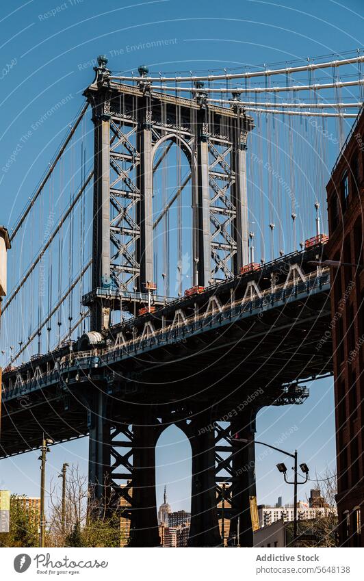 Manhattan Bridge framed between Brooklyn buildings Street DUMBO brick iconic cityscape urban landmark architecture history travel destination New York scene