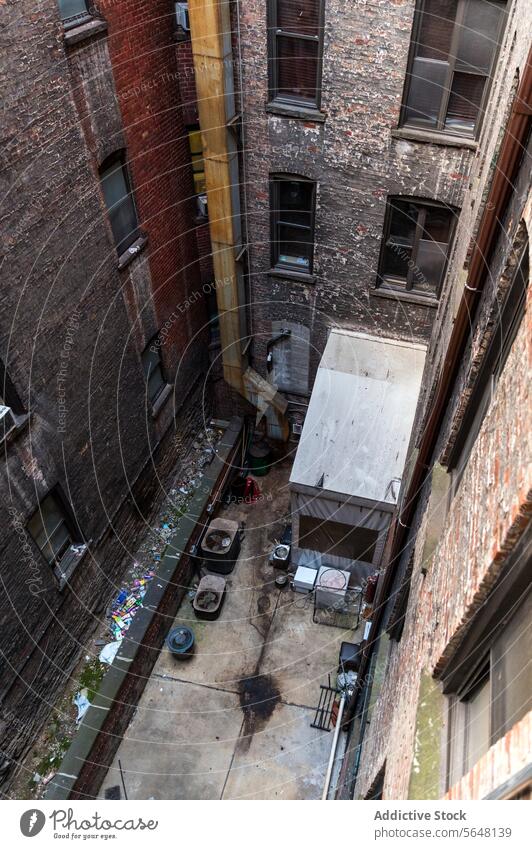 Manhattan backyard clutter from above New York overhead trash shed brick building urban city aerial view mess discarded items rooftop old vintage architecture