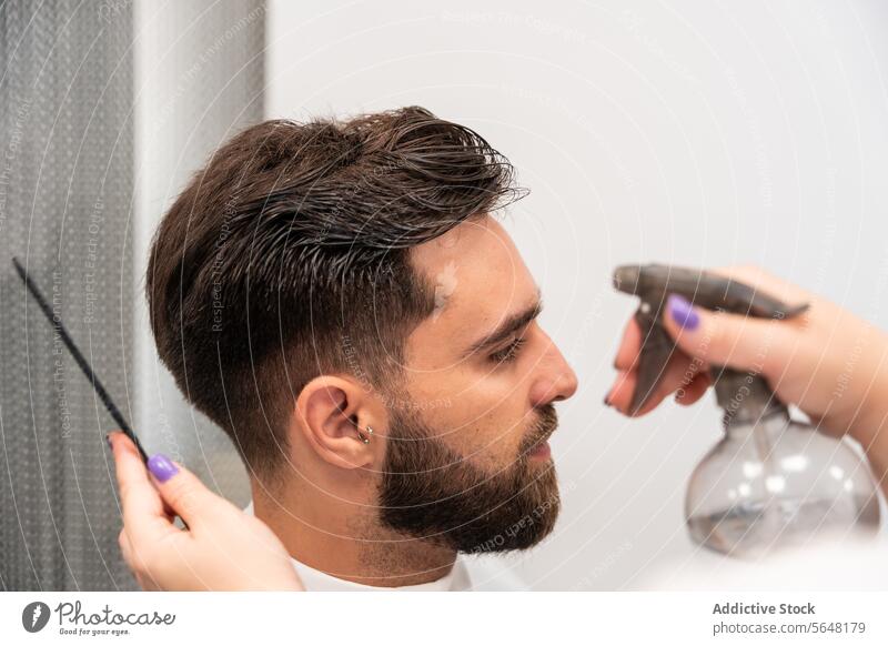 Crop hands of unrecognizable female hairdresser spraying water on male customer's hair in salon Hairdresser Spray Water Man Salon Care Wet Service Handsome Comb