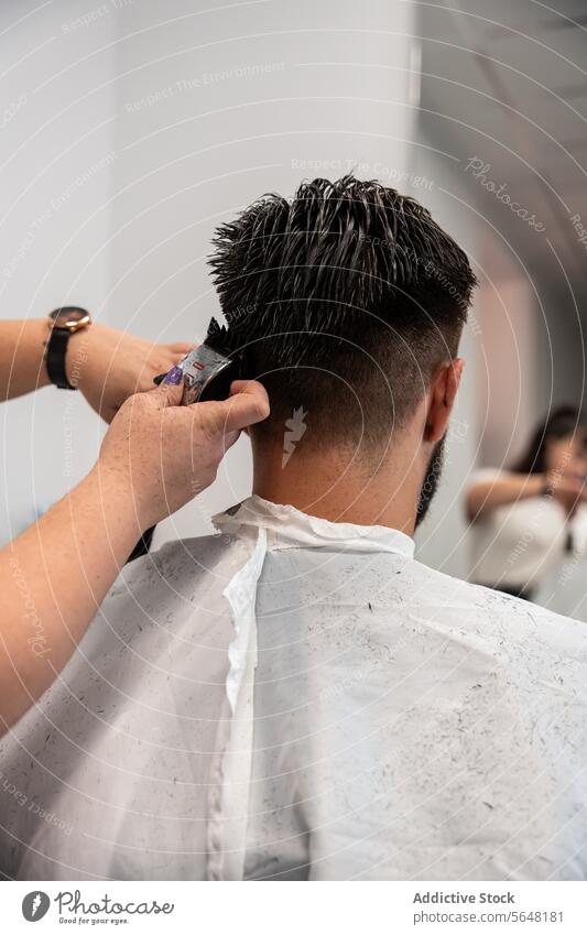 Cropped unrecognizable female hairstylist using electric trimmer on male client's hair at salon Hairdresser Trimmer Man Salon Care Service Hand Client Process