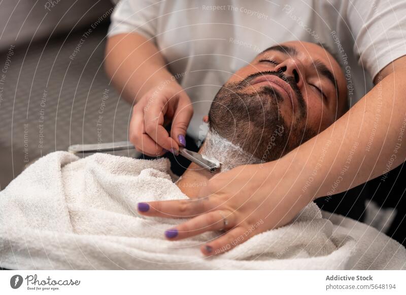 Female barber shaving male client's beard with straight razor Hairdresser Shave Straight Razor Beard Man Salon Care Service Hand Client Tool Job Hairstylist