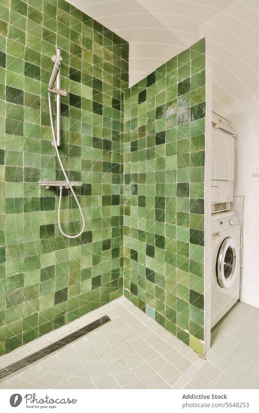 Bathroom with shower and laundry machine bathroom washing dryer green tile apartment luxury appliance modern design house interior home style contemporary clean