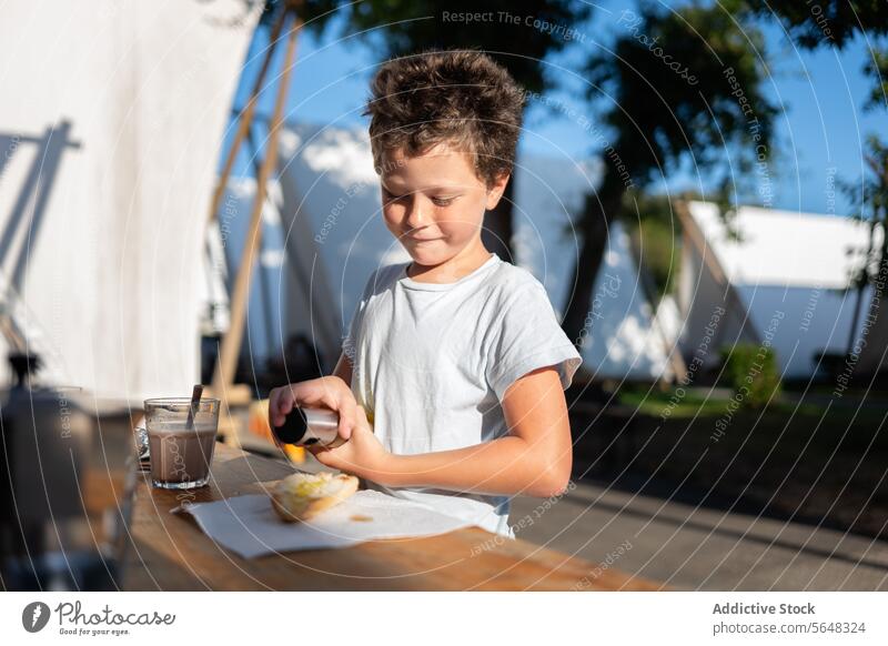 Smiling boy preparing healthy breakfast with coffee prepare kid happy glass smile table fresh energy healthy lifestyle ingredient stand childhood refreshment