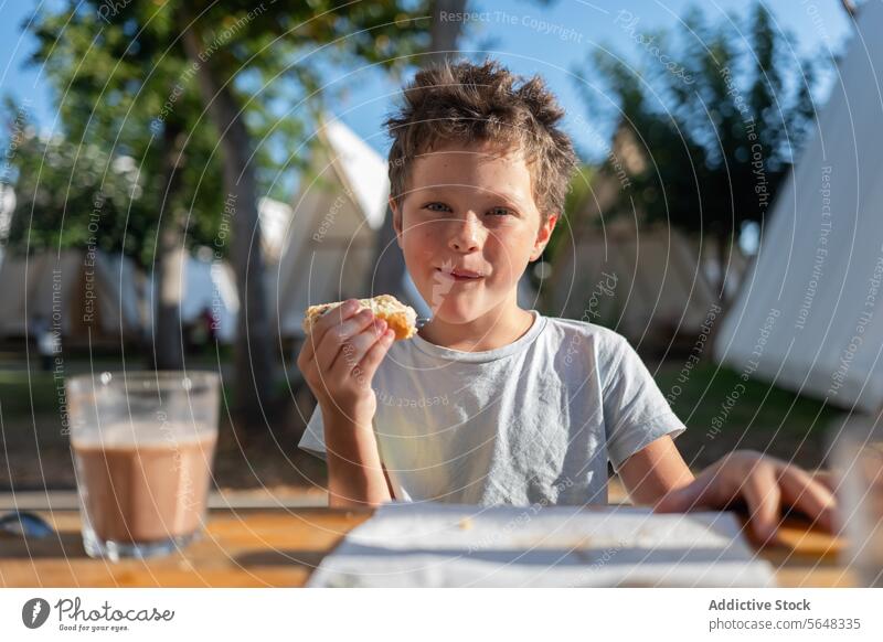 Boy eating a slice of bread healthy breakfast with coffee boy kid happy glass table fresh energy healthy lifestyle ingredient stand childhood refreshment