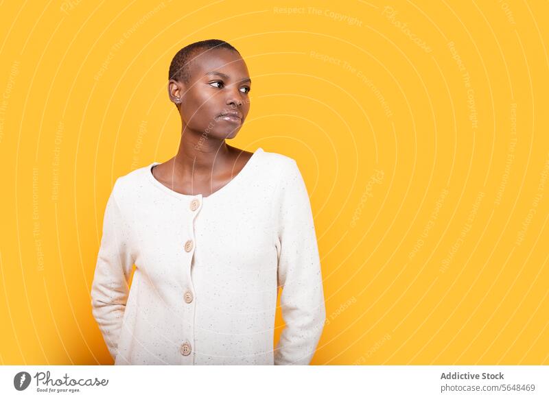Confident black young woman isolated over yellow background confident portrait style serious emotion copy space african american short hair fashion attitude