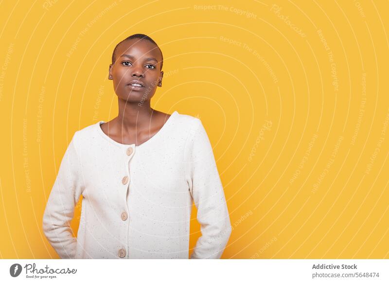 Confident black young woman isolated over yellow background confident portrait style serious emotion copy space african american short hair fashion attitude