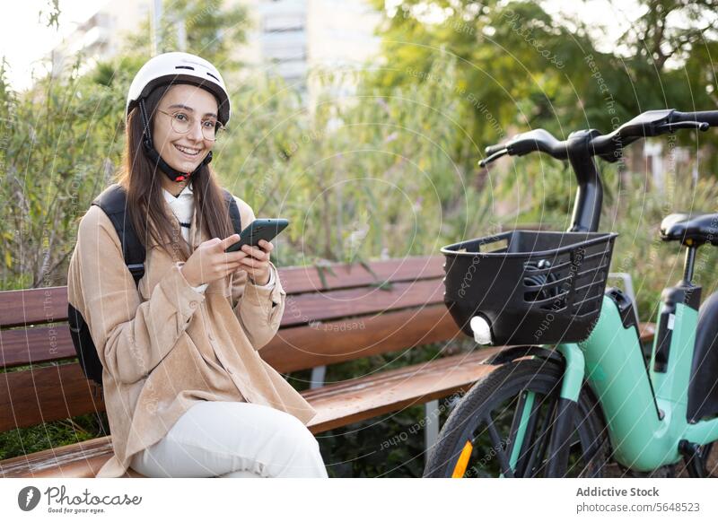 Smiling young woman with e-scooter outdoors helmet smile adult female electric city path sunlit cheerful standing safety transport transportation urban