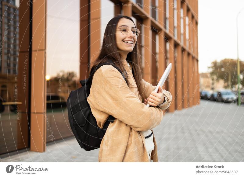 Smiling student with backpack outside college building woman notebook smiling cheerful young modern building education university campus lifestyle outdoor