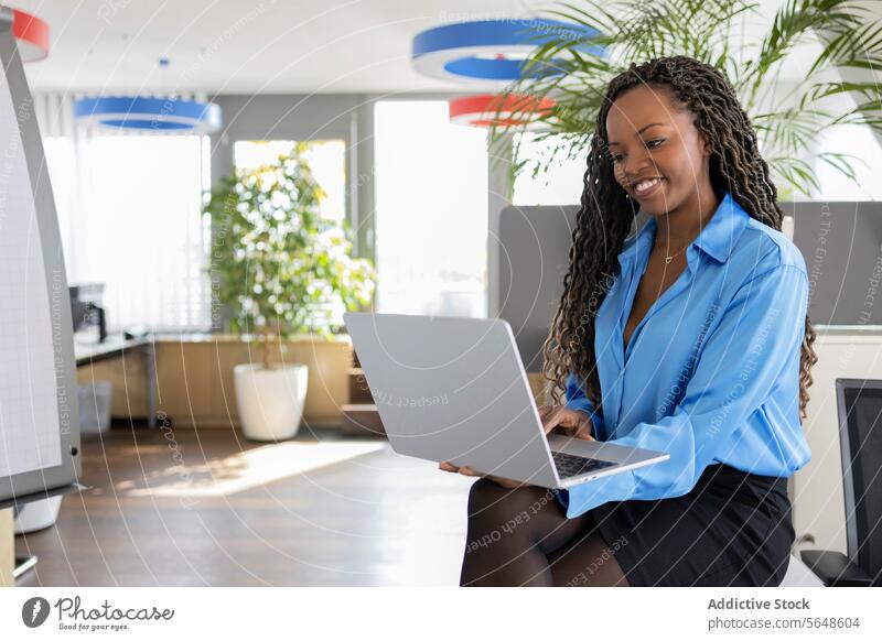 Happy young black businesswoman using laptop in office Businesswoman Laptop Using Office Work Smile Internet Entrepreneur Beautiful Woman Young Afro Formal